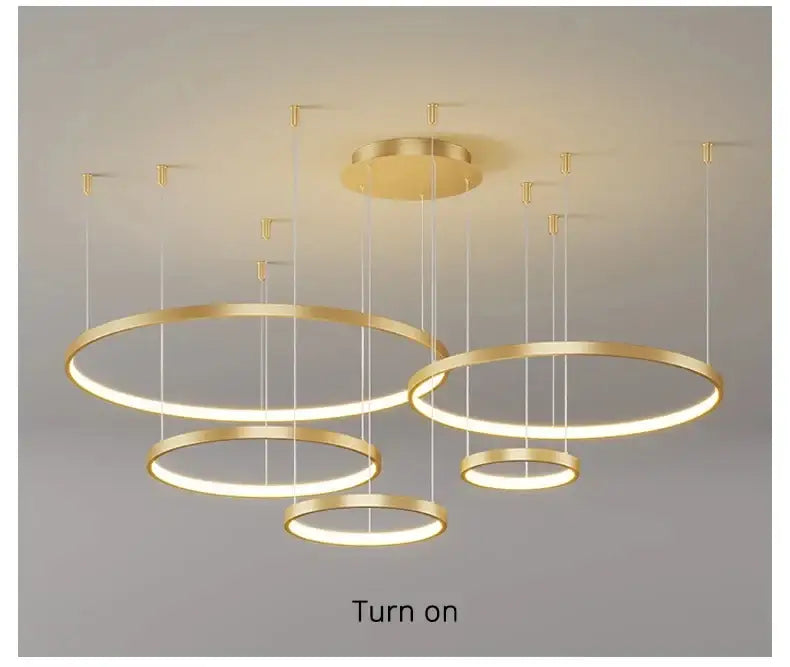 Modern black pendant light by decorbites featuring gold-finished illuminated rings ideal for living room lighting