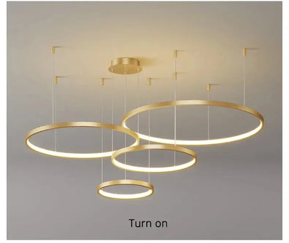 Modern gold-toned circular led chandelier with warm glow featured in DecorBites™ living room pendant light