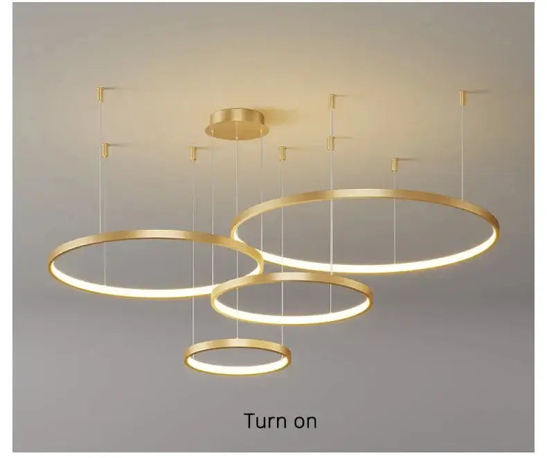 Modern gold-toned circular led chandelier with warm glow featured in DecorBites™ living room pendant light