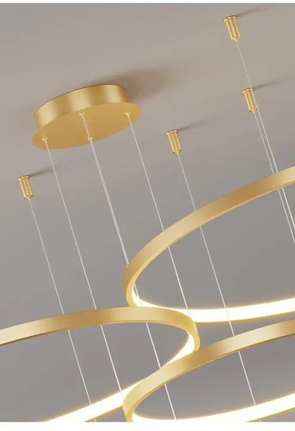 Gold-colored modern chandelier with sleek interlocking rings and thin cables for living room pendant light decorbites modern black pendant