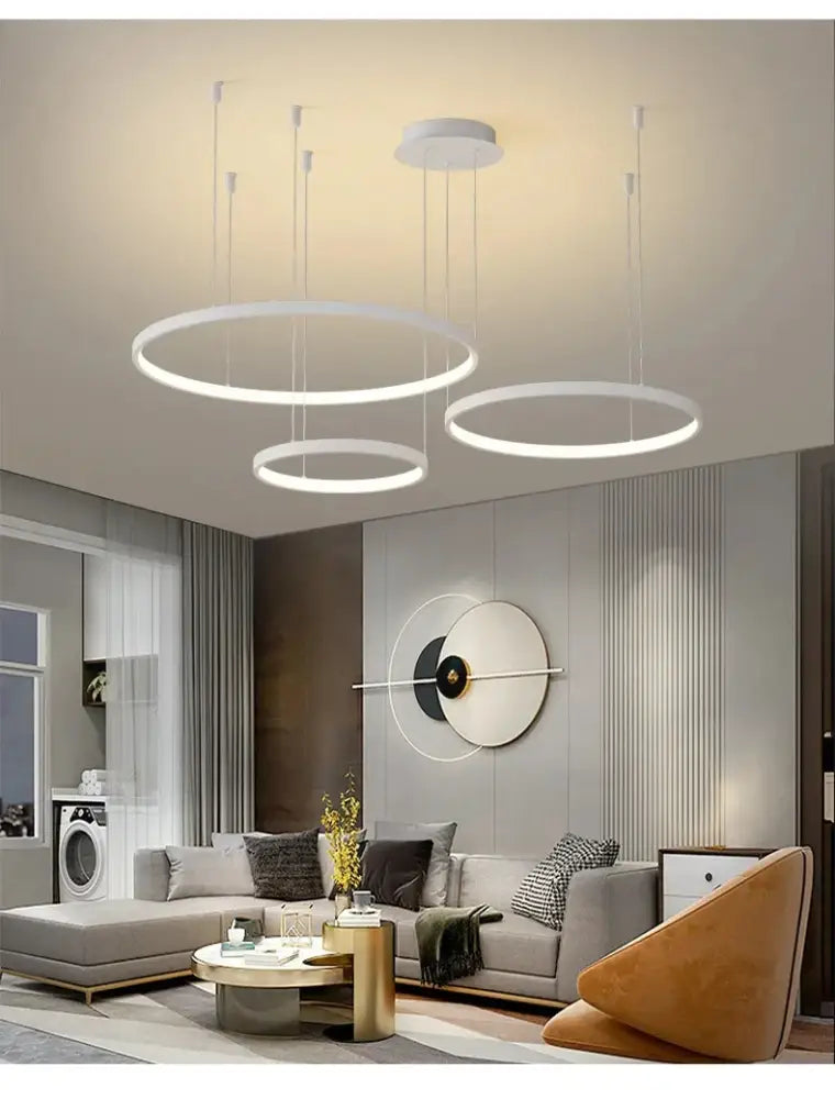 Modern white circular pendant lights with sleek minimalist design complement the DecorBites™ modern black pendant light for living room