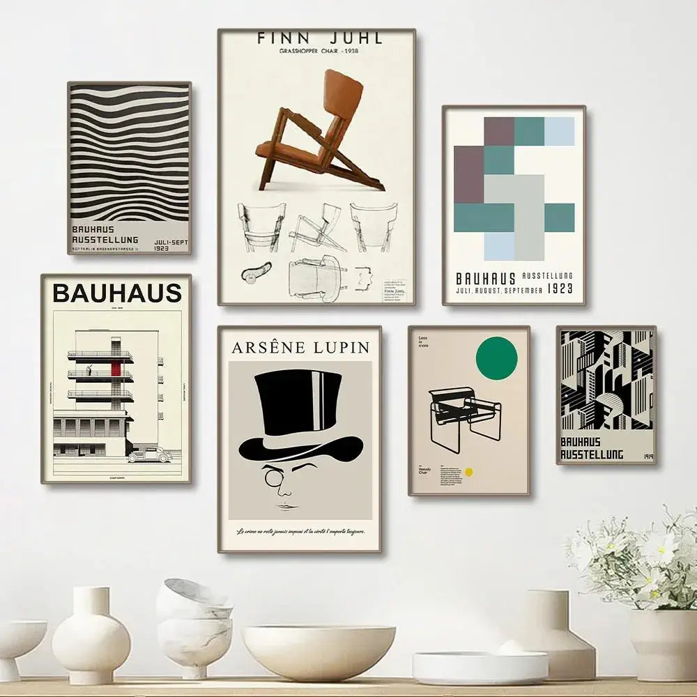 Minimalist beige wall with six framed bauhaus canvas prints featuring bold black white and colored geometric designs