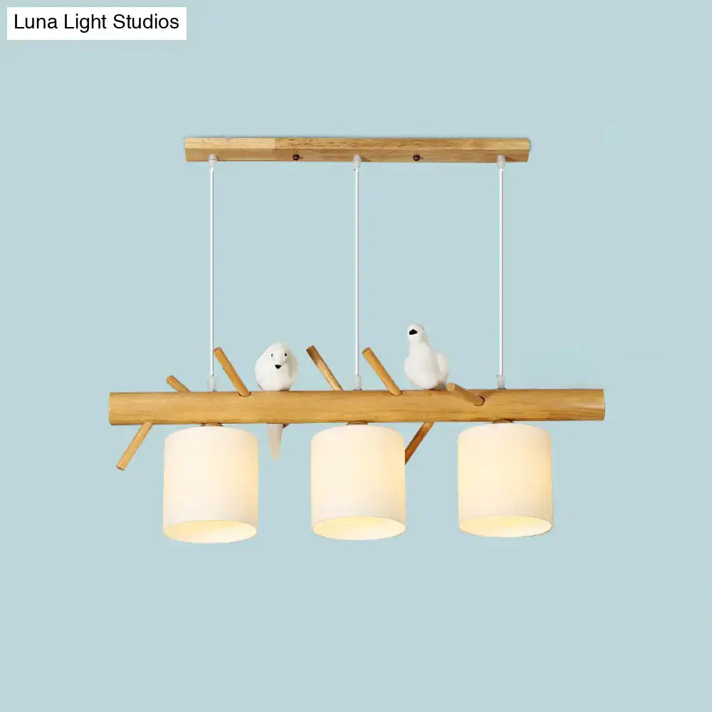 DecorBites modern branch island pendant light with three off-white glass shades and white bird figurines for dining room