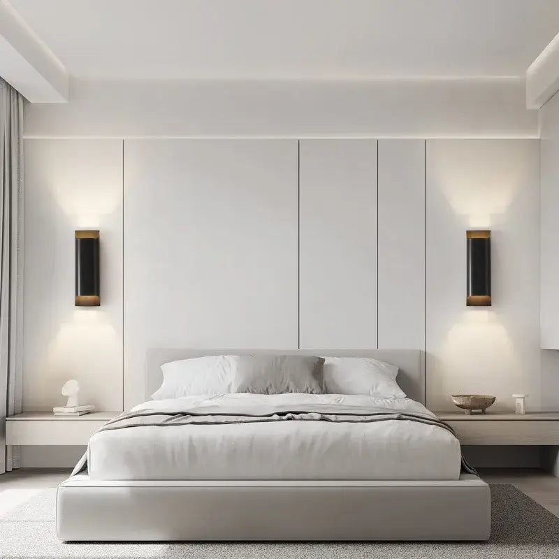 Modern minimalist bed with light gray upholstered frame and white bedding illuminated by decorbites modern brass led wall lamp
