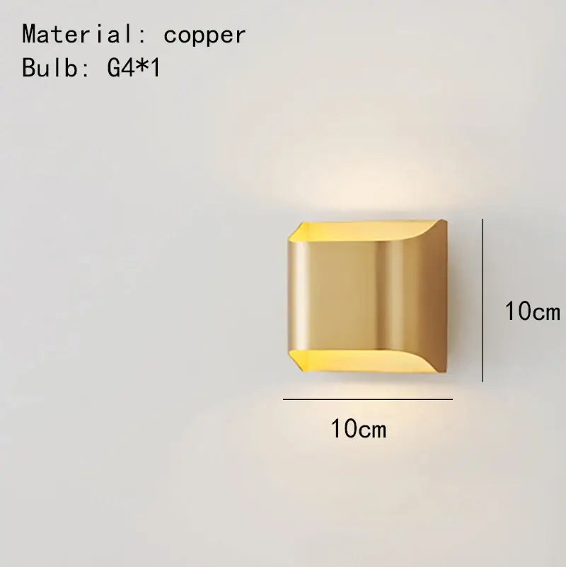 A sleek 10cm square DecorBites wall lamp in modern brass LED with geometric design and warm ambient lighting