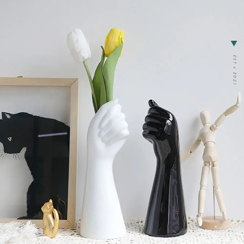 White ceramic arm vase shaped like a raised hand holding tulips modern flower vase by DecorBites™