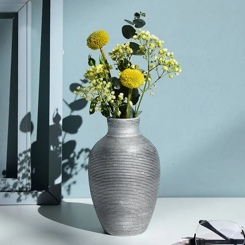 Decorbites™ modern silver ribbed ceramic nordic vase holding yellow and white flowers for home decor