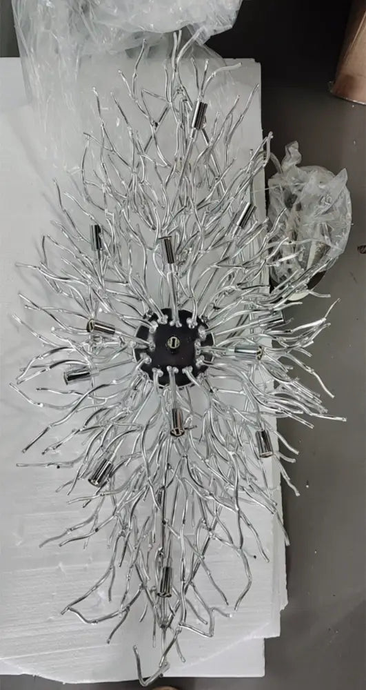 Decorbites™ modern chrome chandelier with silver metallic branching arms and central black hub featuring chrome rectangular crystals