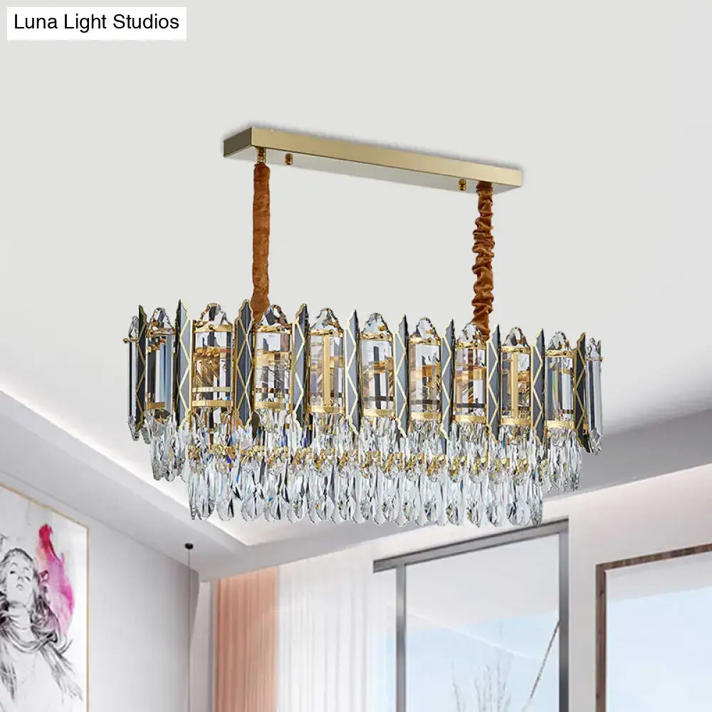 Gold-toned decorbites™ modern crystal tiered oblong island light fixture with clear prisms and teardrop crystals suspended by braided cords