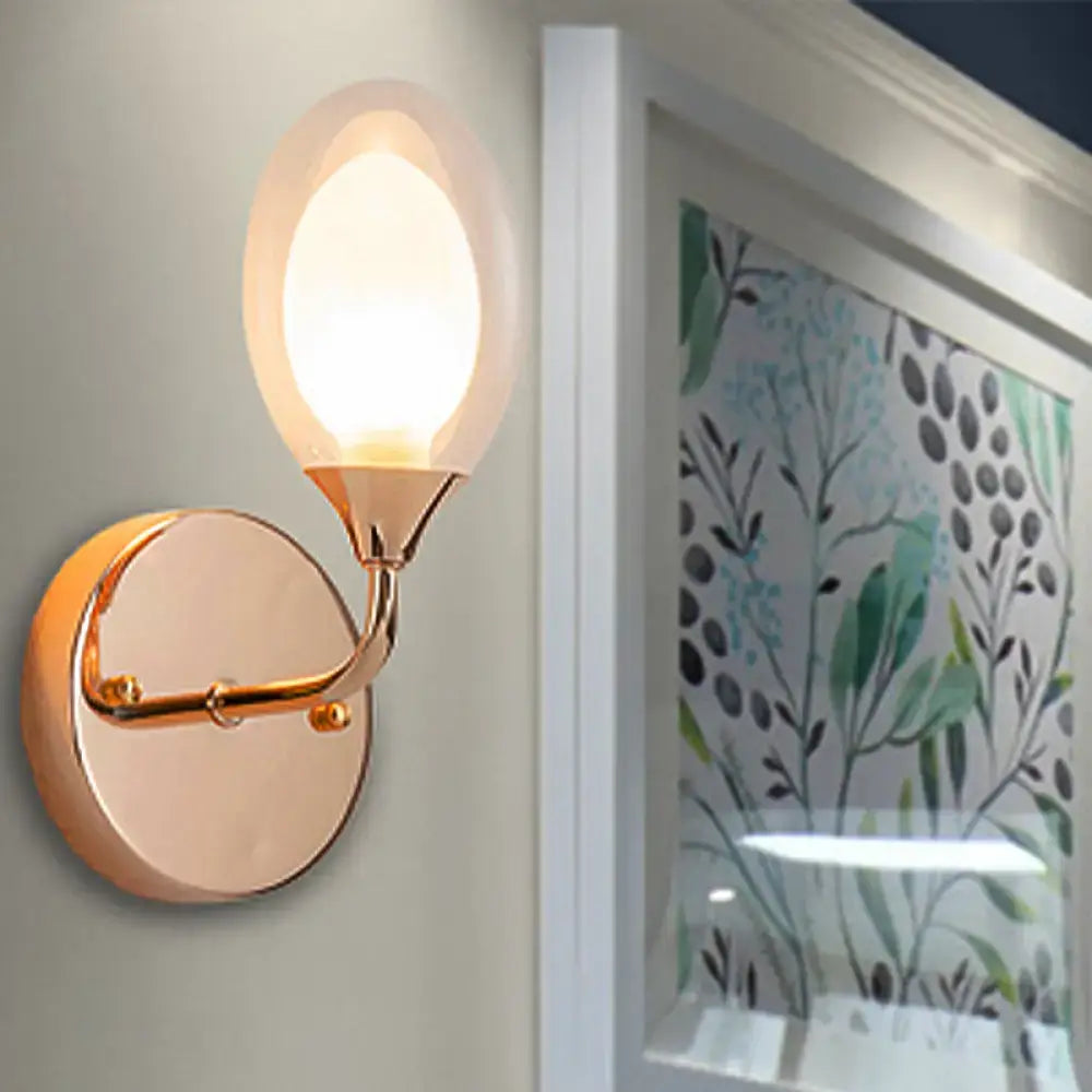 Modern gold wall lamp with frosted glass globe and curved metal arm for bedroom wall light fixture