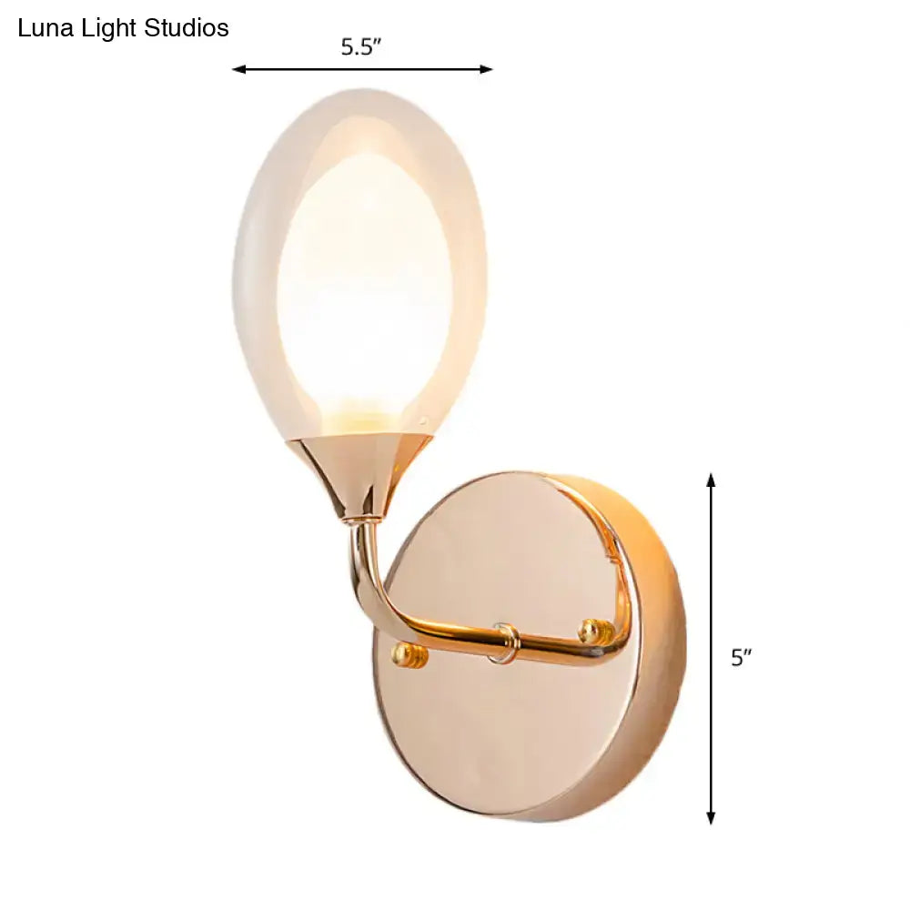 Modern gold wall lamp with frosted glass oval shade designed as a bedroom wall light fixture
