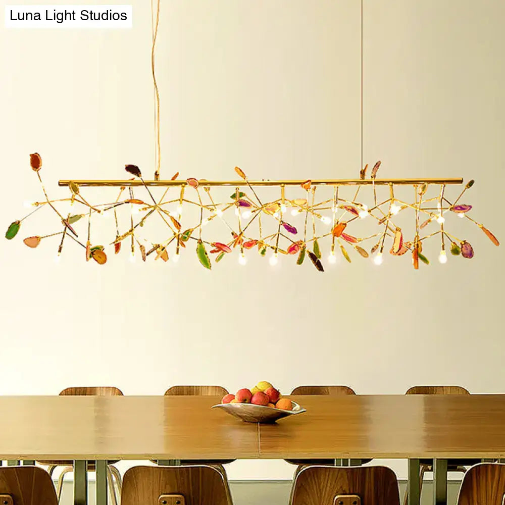 Decorbites modern colorful island light fixture with gold-toned branches, dried leaves, and warm color temperature bulbs
