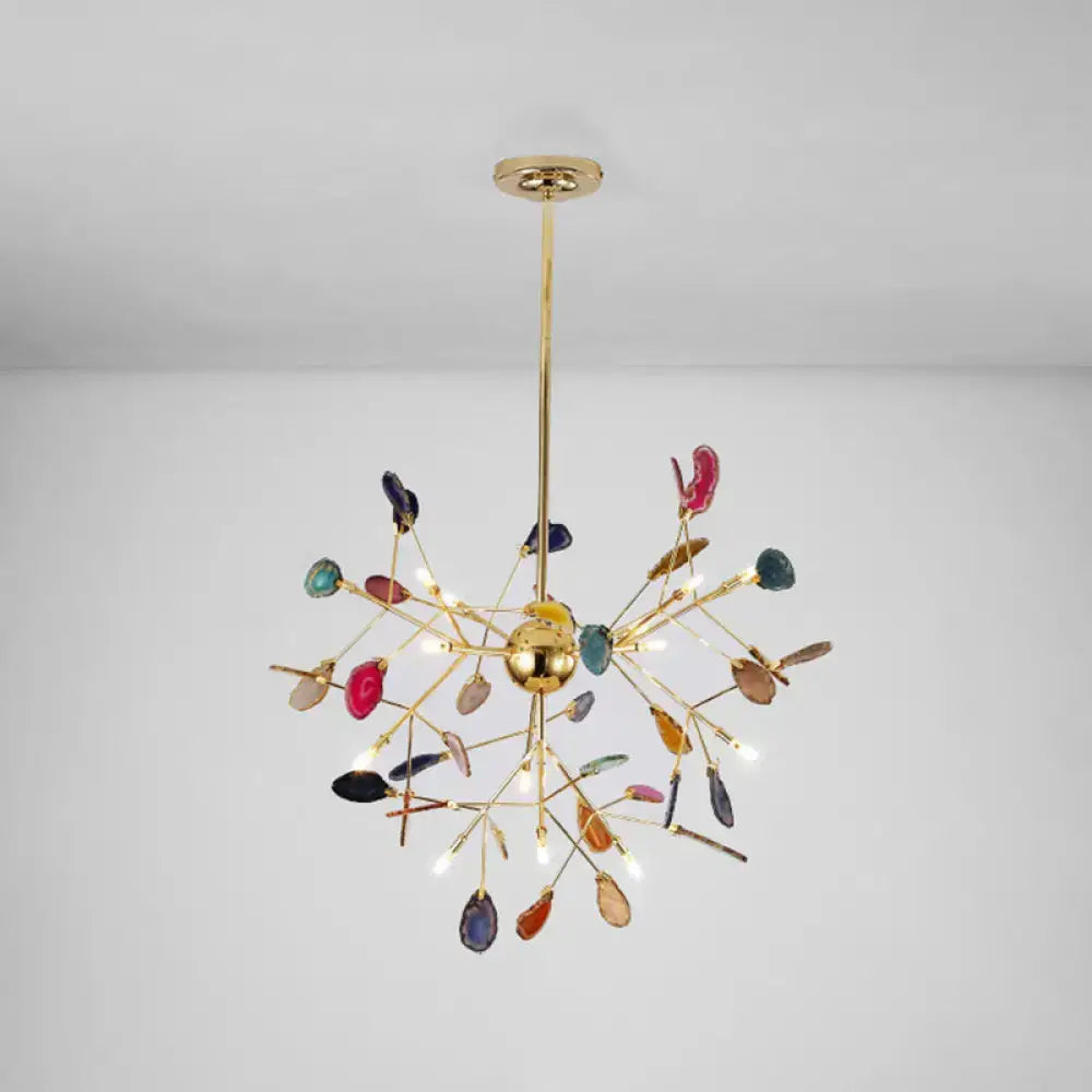 A vibrant gold-toned decorbites modern colorful island light fixture with leaf-shaped glass and warm color temperature