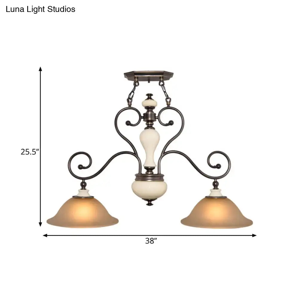 Antique bronze wrought iron chandelier with two warm white glass shades and cream ceramic accent for dining room lighting