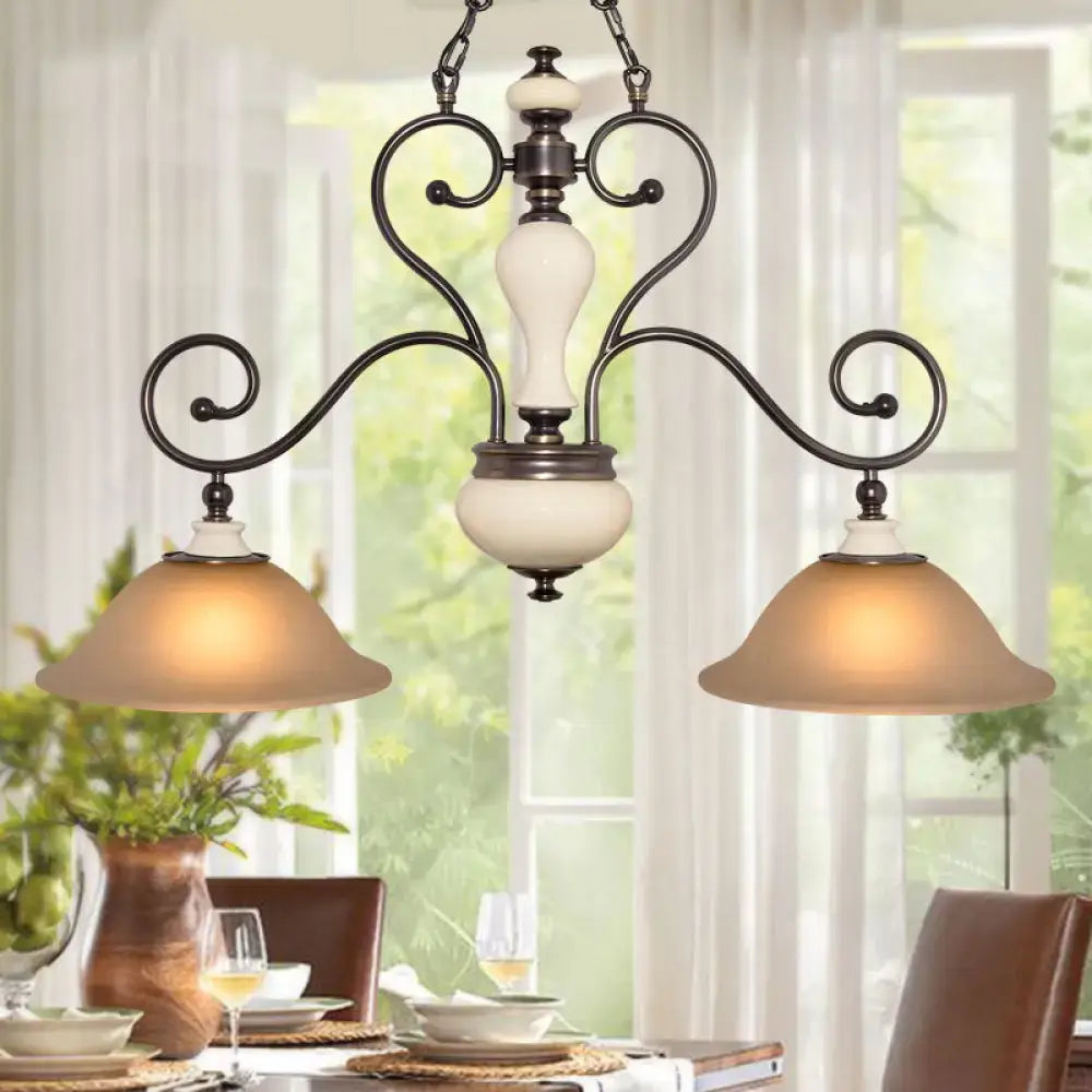 Antique bronze-finished chandelier with elegant curved arms and cream-colored white glass shades for dining room