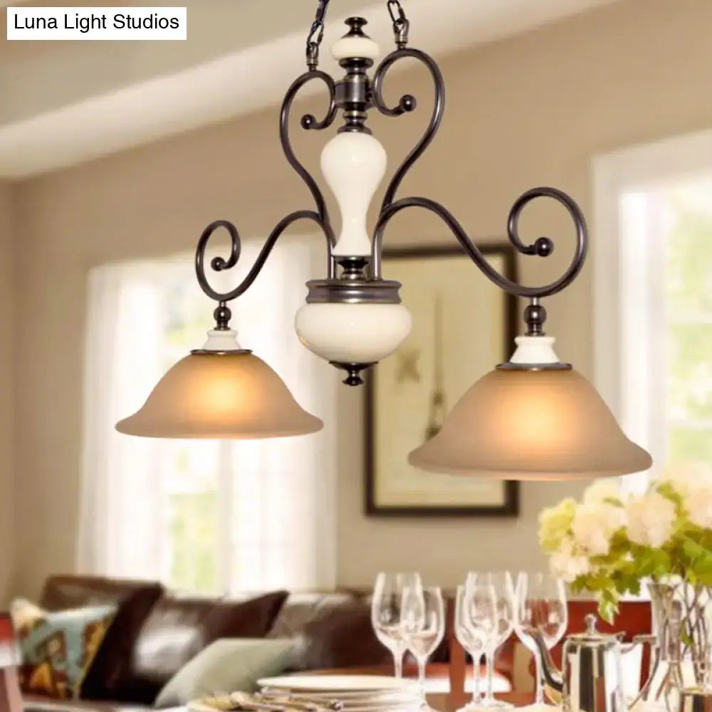 Antique bronze wrought iron chandelier with cream ceramic accents and white glass black frosted shades for dining room