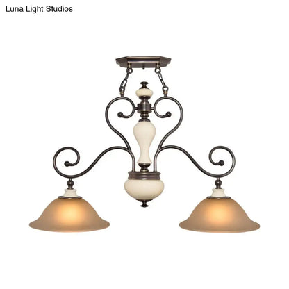 Antique bronze chandelier with cream white glass and ornate scrollwork arms perfect for dining room lighting