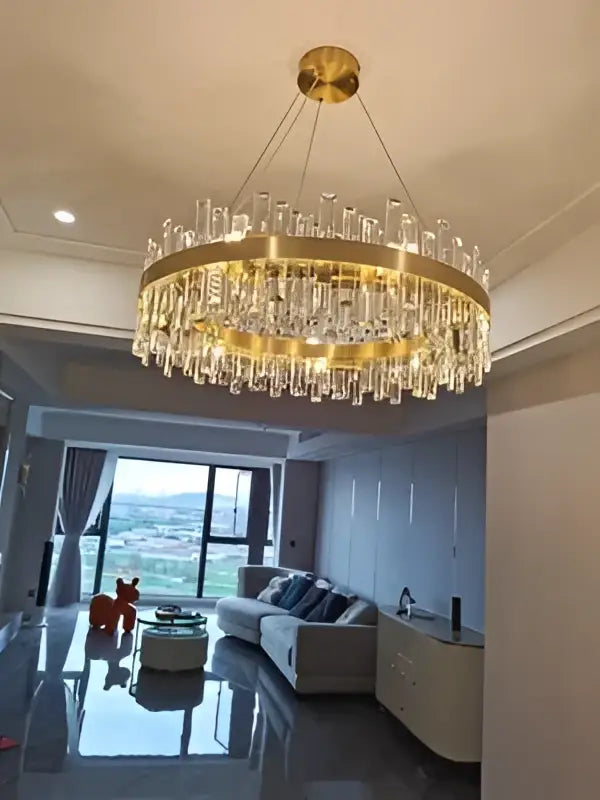 Decorbites modern crystal chandelier with gold-toned frame and hanging crystal rods for dining room lighting