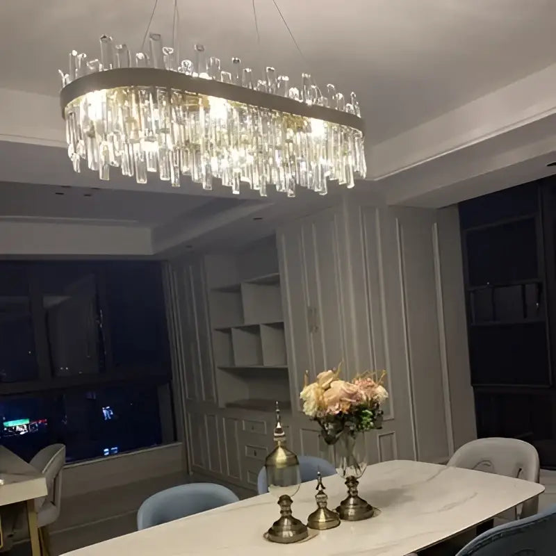 DecorBites modern oval crystal chandelier with cascading clear prisms and golden chrome frame for dining room lighting