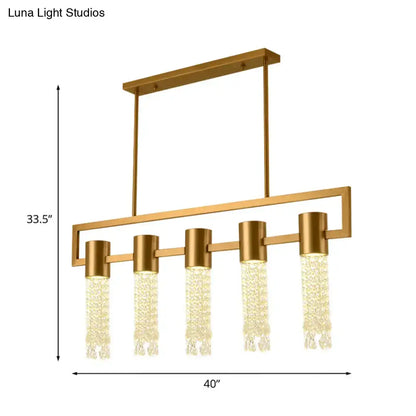 Gold-toned modern crystal draping lighting fixture with five cascading pendant lights for island pendant use
