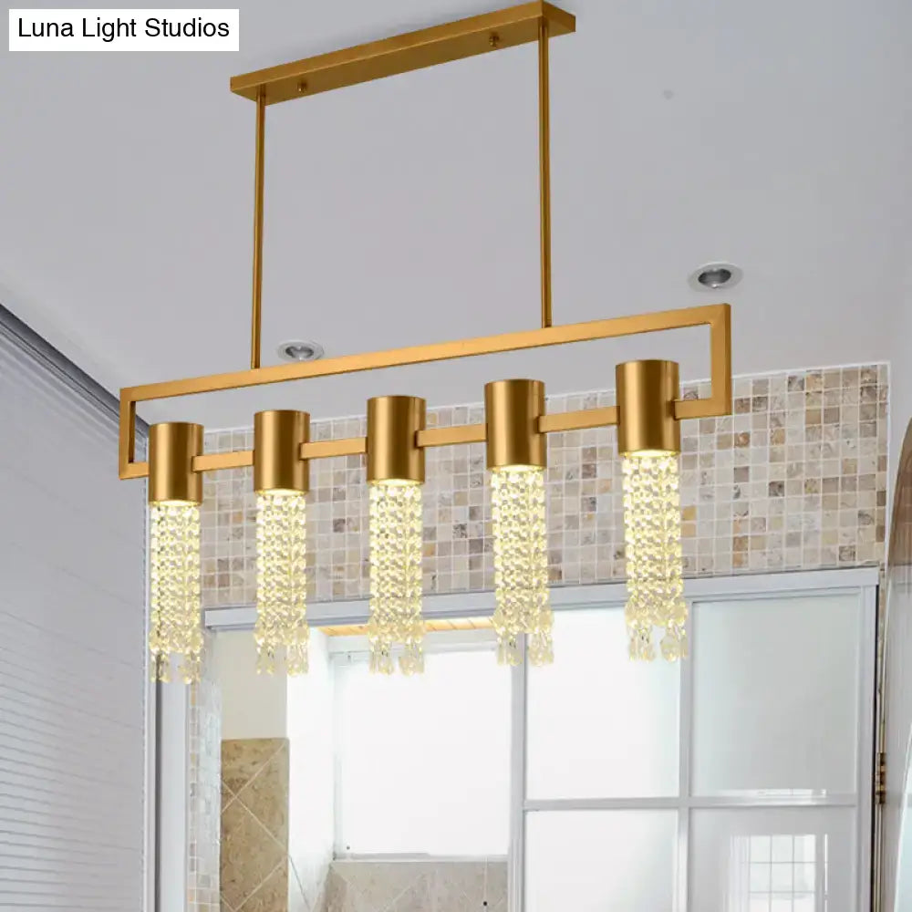 Decorbites modern gold-toned lighting fixture with crystal draping and five cylindrical pendants for island pendant use