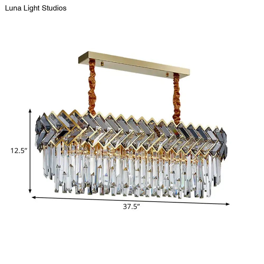 Gold-toned rectangular decorbites pendant light with zigzag crystal facets and braided copper chain cord length for dining room