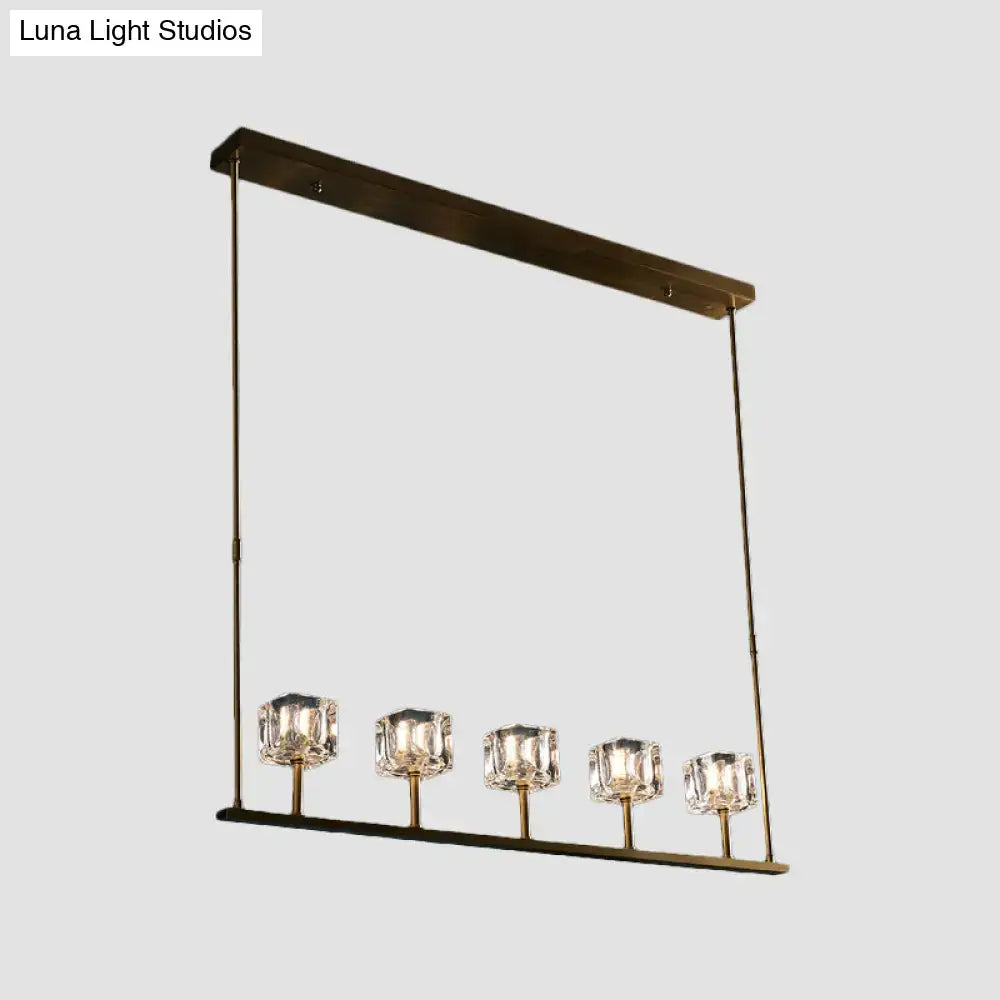 Modern brass-finished rectangular hanging island pendant light with five crystal glass shades for dining area fixture width
