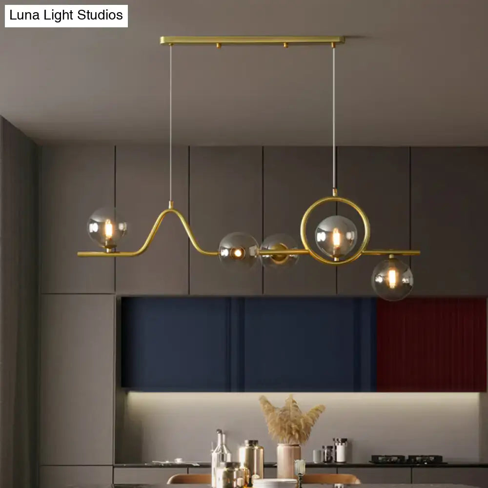 Decorbites modern curve island ceiling light with gold-toned metal arms and clear glass globe bulbs for dining room