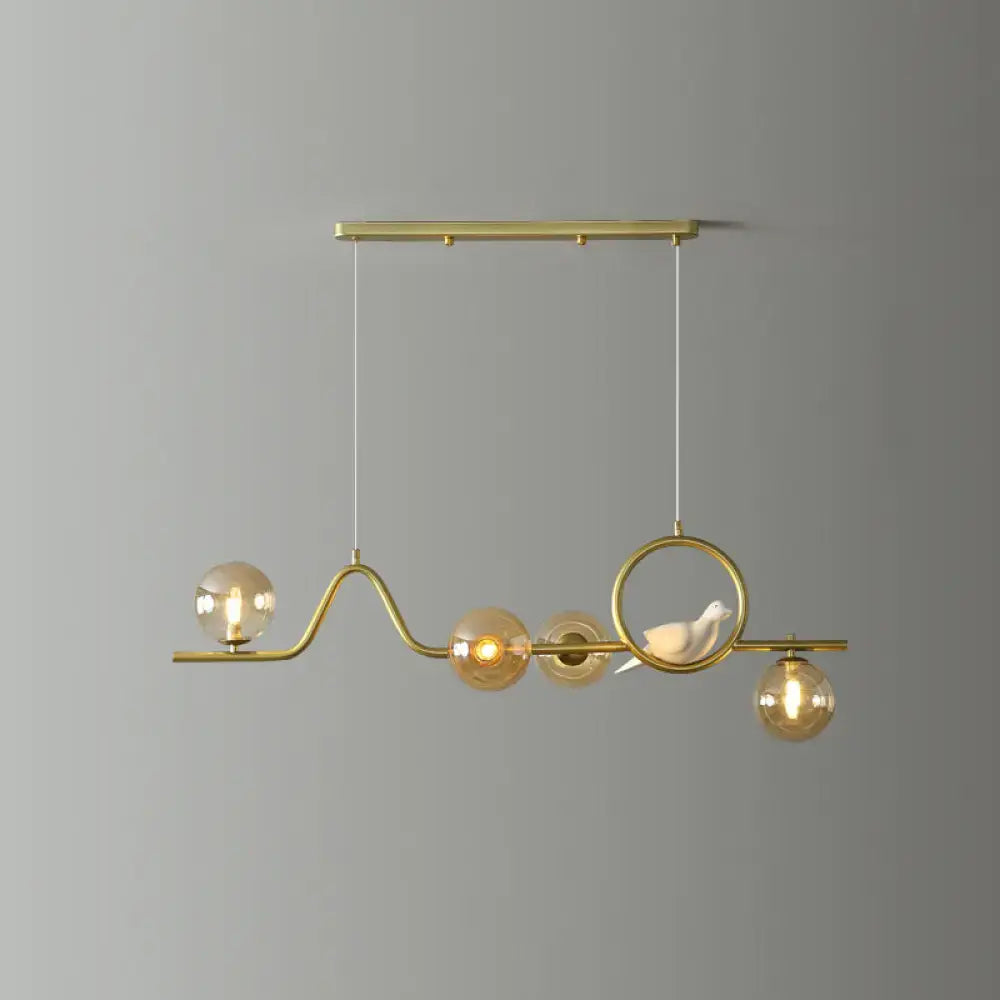 DecorBites modern curve island ceiling light with gold-toned metal frame amber glass bulbs and white ceramic bird
