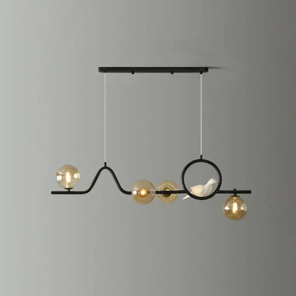 Black metal DecorBites™ curve island ceiling light with four amber glass globes and a white ceramic bird for dining room