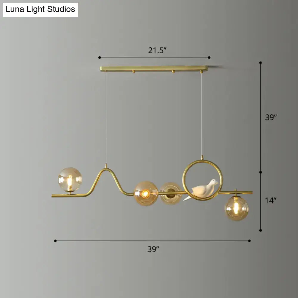 Decorbites modern curve island ceiling light with gold-toned metal frame amber glass globes and ceramic bird figurine