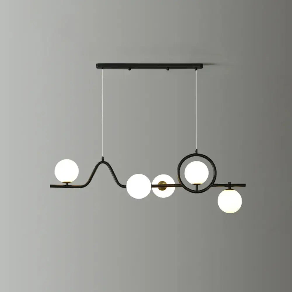 Modern black metal curve island ceiling light with five frosted glass globe bulbs for dining room illumination