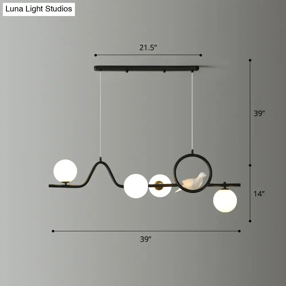 Black metal curve island ceiling light with five white glass bulbs and circular ring with bird figurine for dining room