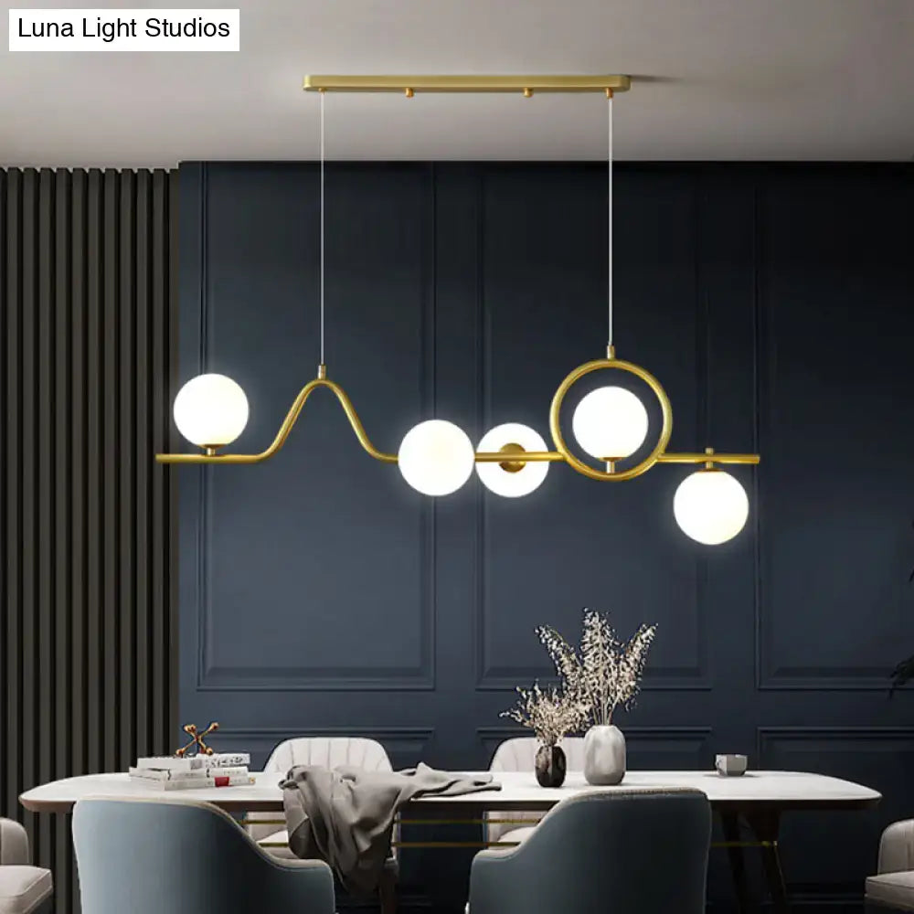 DecorBites modern gold-toned curve island ceiling light with five white glass ball shades for dining room