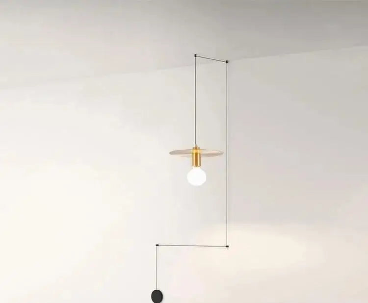 DecorBites™ modern diy pendant light with brass circular shade, black cable, and exposed bulb in geometric frame