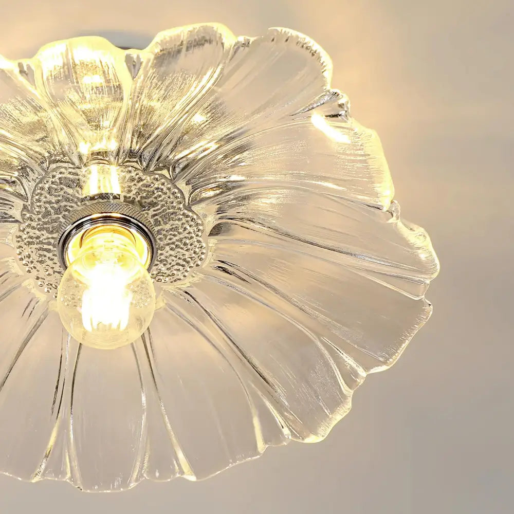 Clear glass ceiling light fixture with vintage glass shade and modern flower design featuring a central bulb