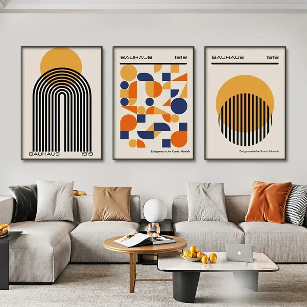 Three framed DecorBites modern geometric canvas wall art prints with black orange and blue designs on cream background