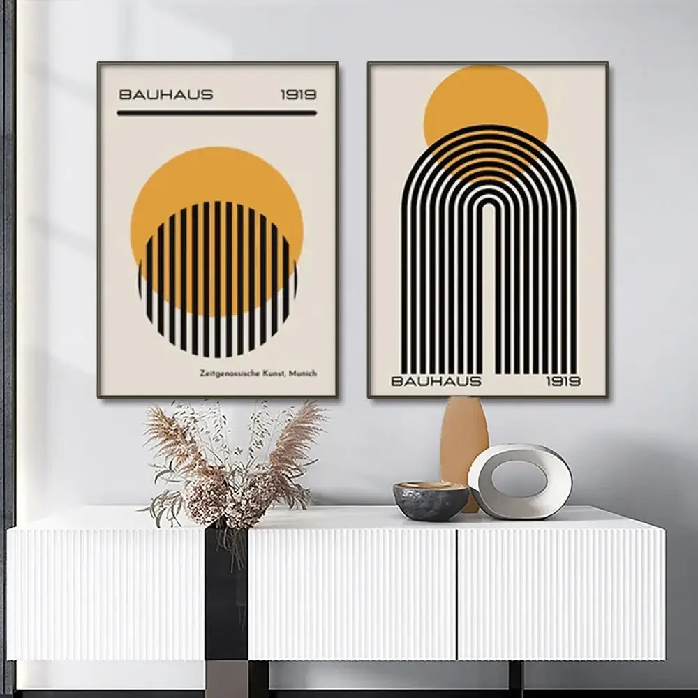 Two minimalist bauhaus 1919 framed posters with bold black and ochre geometric designs on cream modern geometric canvas wall art