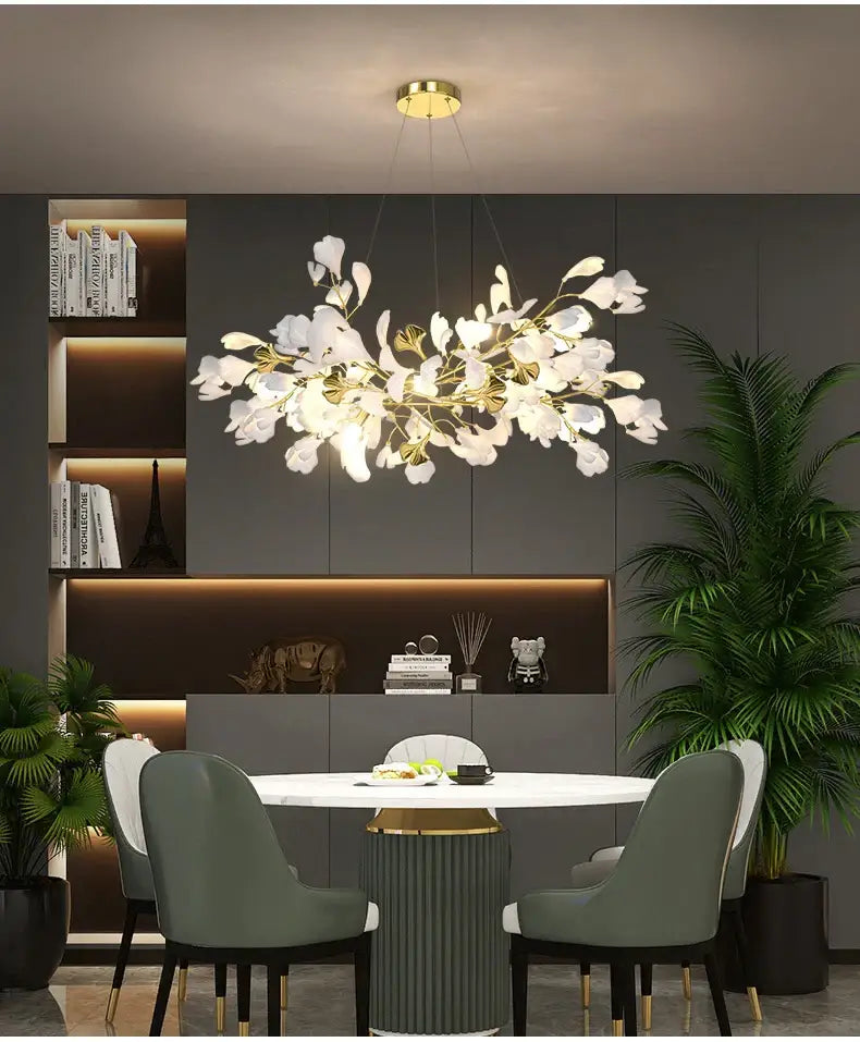 Elegant white orchid-shaped DecorBites™ modern ginkgo leaf LED chandelier with gold accents for dining room lighting