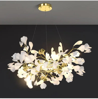 Elegant white and gold DecorBites™ modern ginkgo leaf LED chandelier designed for dining room lighting