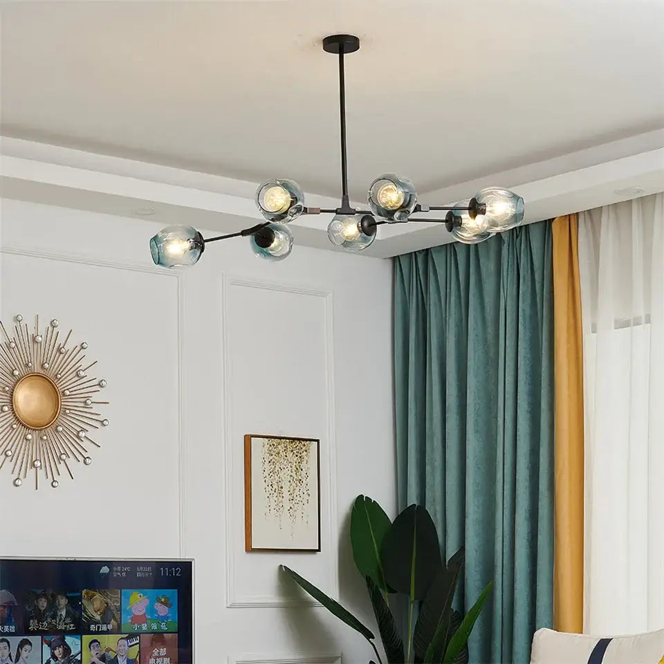 Modern black gold metal chandelier featuring six clear nordic glass ball bulbs for elegant indoor lighting
