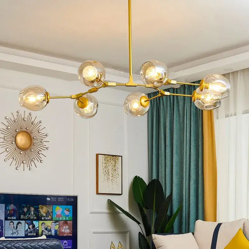 Gold-toned DecorBites™ modern glass ball pendant chandelier with multiple nordic glass ball bulbs in black gold finish