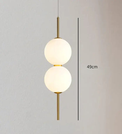 DecorBites™ modern glass pendant lighting with gold-toned fixture and two vertically stacked frosted glass spheres