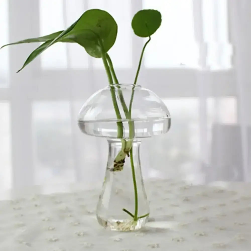 Clear glass mushroom-shaped DecorBites™ modern glass vase terrarium holding two green leafy stems