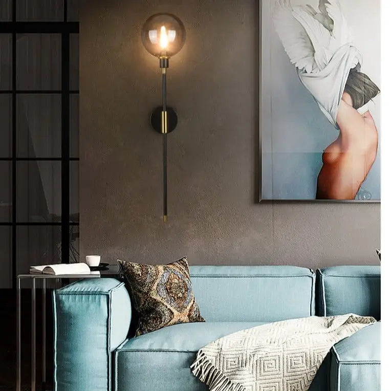 DecorBites™ modern glass wall sconce with spherical glass bulb and brass accents for elegant lighting solutions
