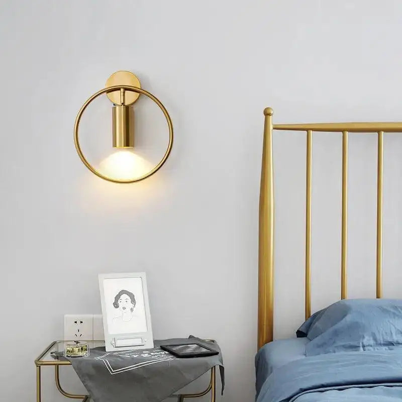 Decorbites™ modern gold and black wall sconce featuring a gold-toned circular wall lamp with a cylindrical light fixture