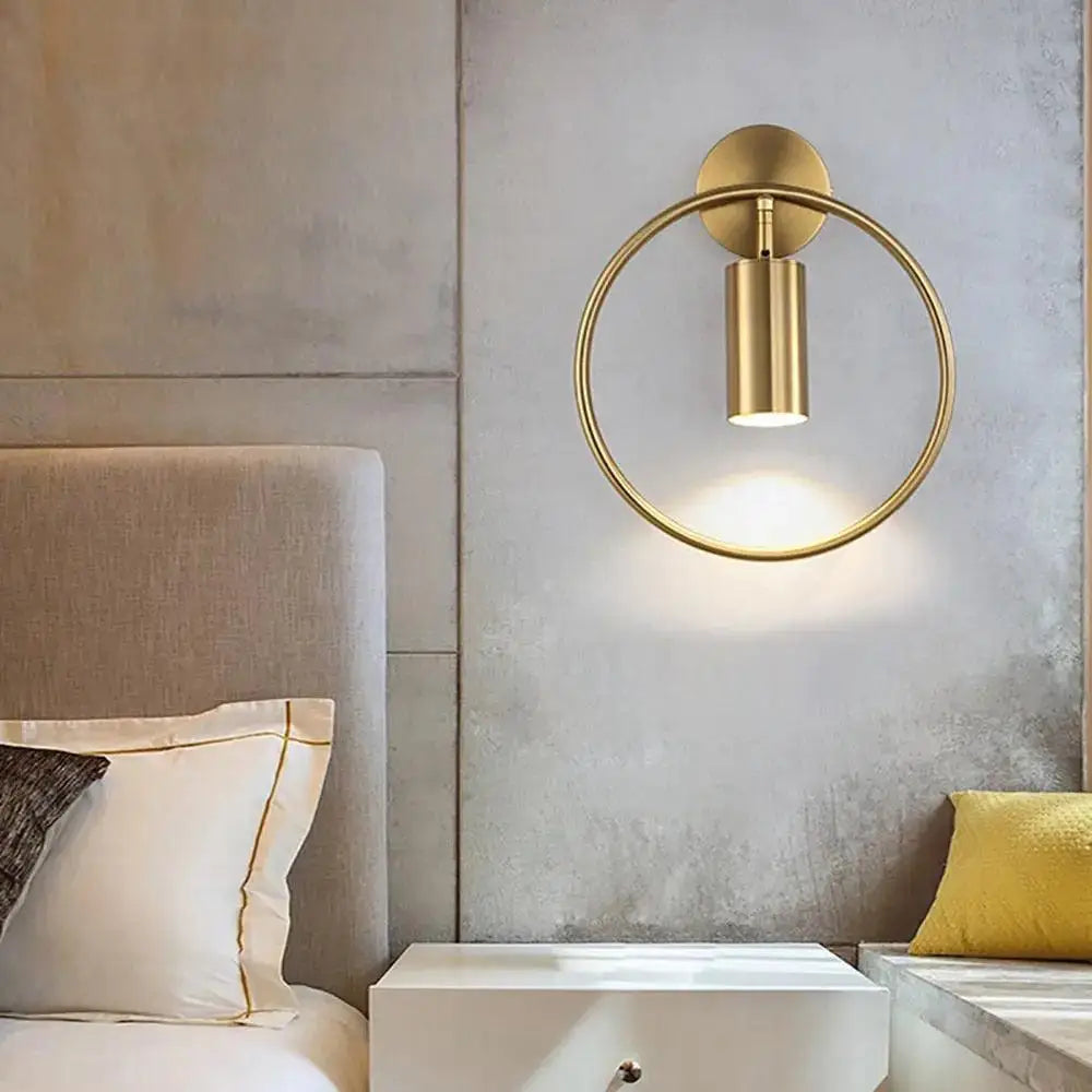 Decorbites modern black gold wall sconce with a gold-toned circular base and cylindrical light fixture wall lamp