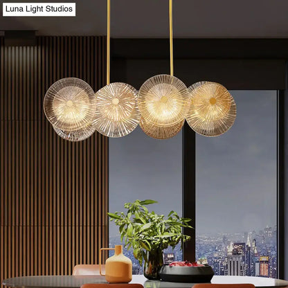 Modern gold finish DecorBites pendant light with prismatic glass shade featuring four etched circular LED bulbs