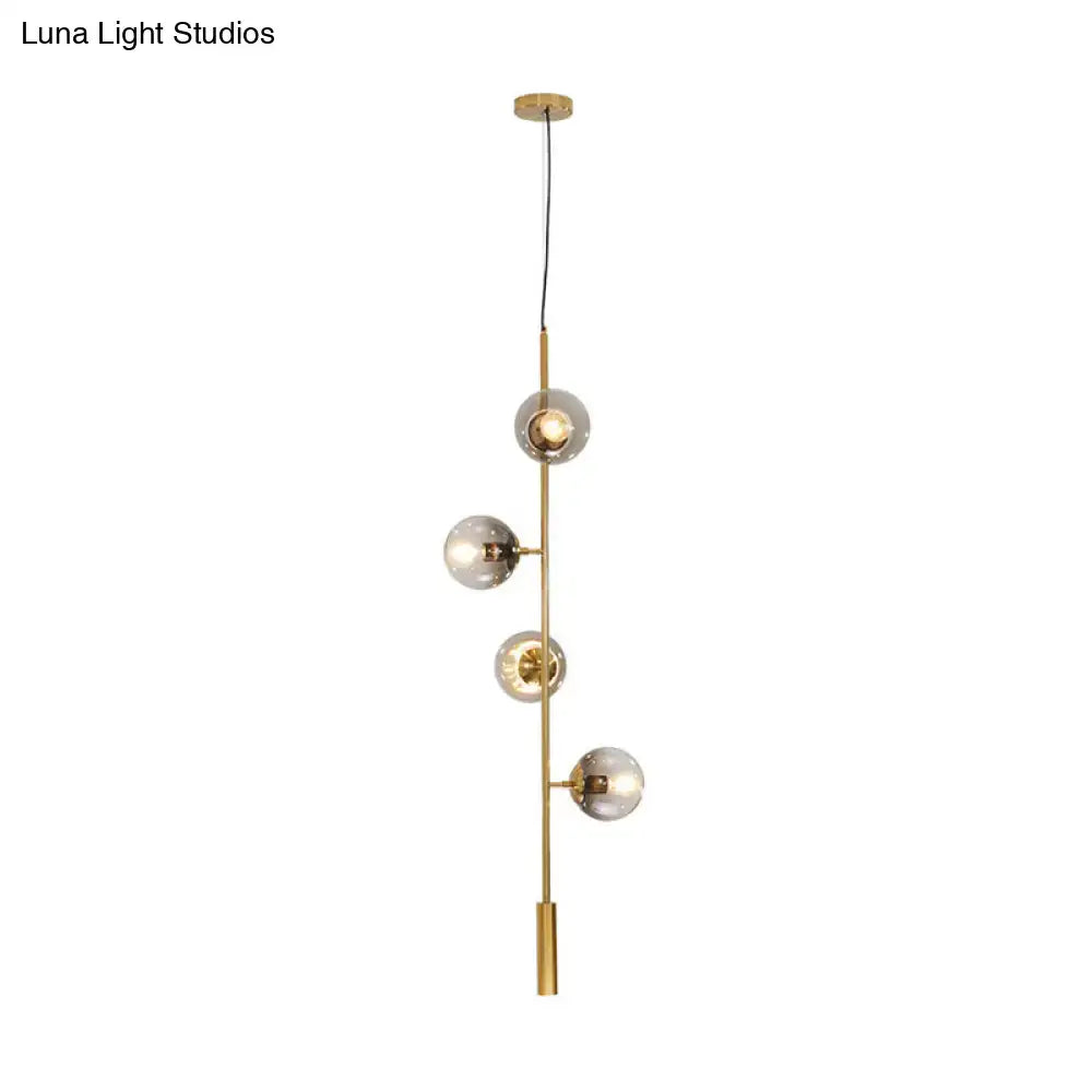 DecorBites modern gold linear chandelier with five frosted gray glass shades on a slender metal rod hanging fixture
