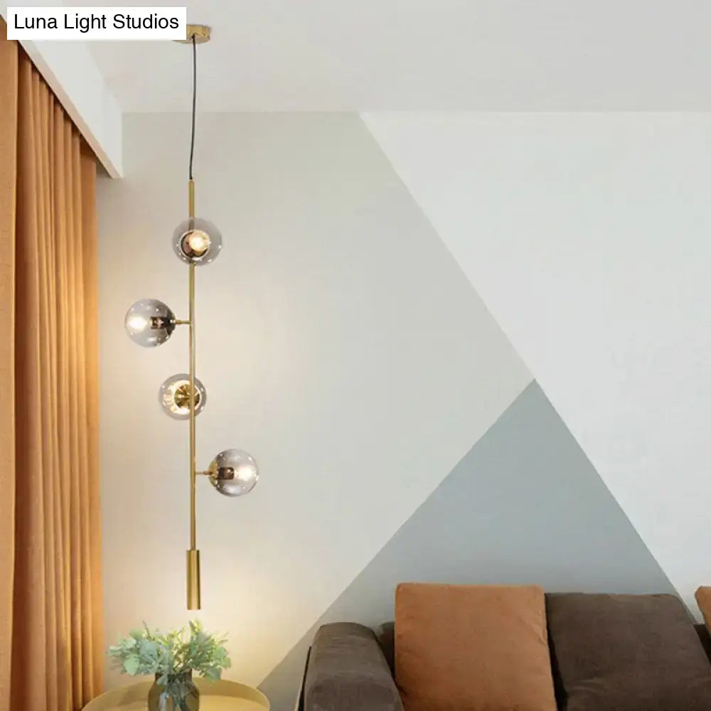DecorBites modern gold linear chandelier with brass finish and four gray glass shades pendant light fixture